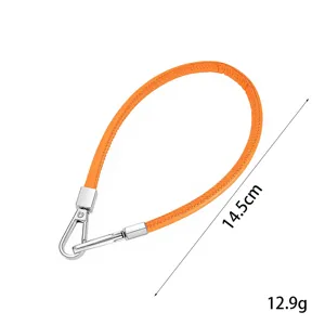 Orange PU leather wrist strap phone lanyard with silver tone double buckle hardware detail.