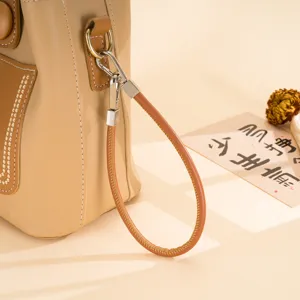 Detailed view of the PU leather wrist strap, featuring fine stitching and metal clasps.