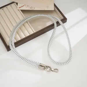 Silver metallic coiled phone strap detail, durable TPU lanyard featuring secure metal clasps.