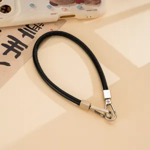 Black PU leather wrist strap with metal double buckles, versatile phone lanyard chain accessory.