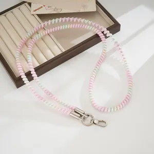 Colorful TPU telephone wire phone lanyard detail showing the cute pastel spiral bead strap design.