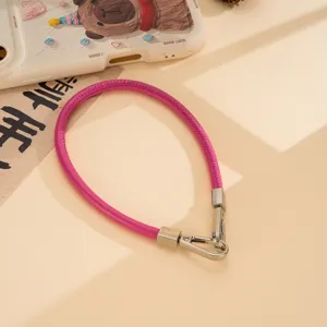 Pink PU leather phone wrist strap with metal buckles, versatile short hand carrying chain.