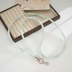 Colorful TPU telephone cord phone lanyard detail shot, pastel coiled strap with metal clasps.