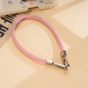 Pink PU leather phone wrist strap with silver metal double buckles, stylish accessory.