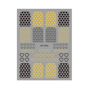 Detailed view of 3D heart pattern nail art sticker sheet with gold and black sticker designs.