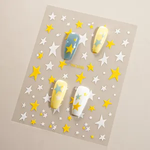 Detailed view of 3D star nail stickers featuring cute blue and yellow star patterns.