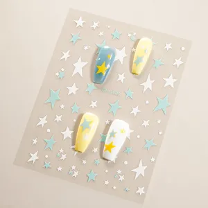 Close-up detail of 3D star nail stickers sheet with cute blue white yellow stars.