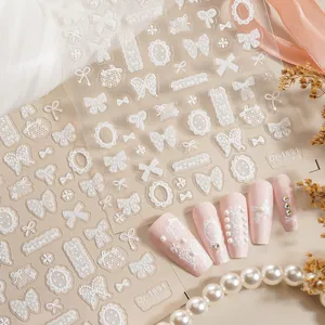 Detail shot of white 5D embossed lace and bow nail stickers featuring exquisite relief textures.