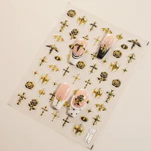 Detailed view of 5D embossed gothic gold and black nail stickers featuring crosses and roses.