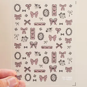 5D embossed nail stickers featuring elegant lace bows and black frames for cute manicures.