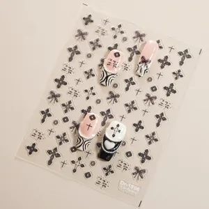 Close-up detail of 5D embossed gothic cross and bow nail stickers sheet with display tips.