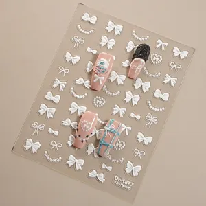 5D reliëf nagelstickers met strikken en parels voor elegante nail art en manicure.