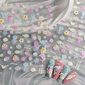 Detailed view of 5D embossed ocean nail art stickers featuring cute dolphins and jellyfish.