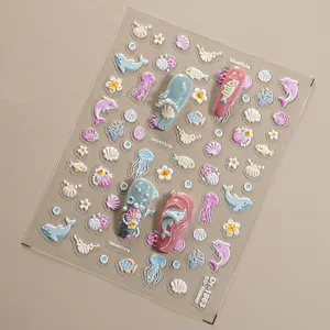 Detailed close-up view of 5D embossed ocean nail stickers featuring dolphins and shells.