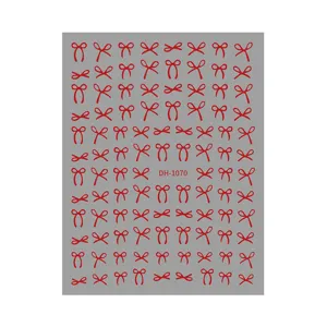 Red bow nail art sticker sheet detail showing multiple cute ribbon designs for DIY manicure.