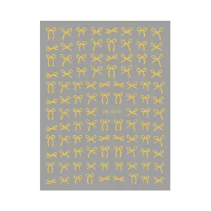 Gold bow nail art sticker detail, exquisite foil bow design for DIY manicure decor.
