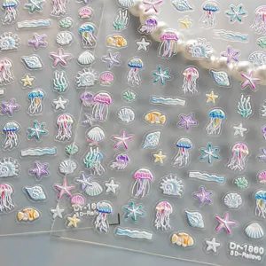 Detail shot of 5D embossed ocean theme nail art stickers featuring cute jellyfish and starfish.