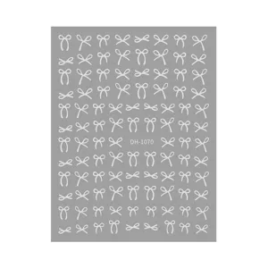 Detailed close-up view of silver bow nail stickers sheet, showing delicate patterns.
