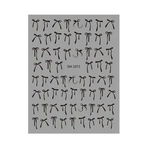 Black bow nail art stickers sheet, cute ribbon designs for DIY manicure decoration.