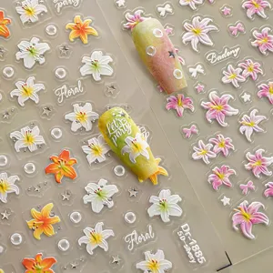 Close up view of 5D embossed lily flower nail art stickers with silver foil and delicate details.