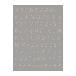 Gold foil alphabet and number nail sticker detail view, elegant metallic typography design.