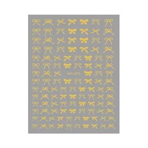 Gold bow nail stickers detail view, delicate metallic foil design for manicure art decoration.