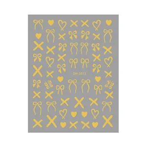 Detailed close-up of gold bow nail stickers with cute hearts and cross patterns for DIY art.
