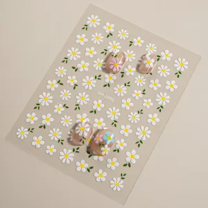 3D floral nail art stickers sheet with cute white daisy designs for DIY manicure decoration.