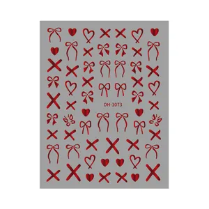 Red metallic bow heart nail sticker detail sheet, glossy foil adhesive nail art accessory.