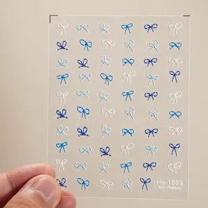 Detailed close-up view of 5D embossed blue and white bow nail art stickers sheet.