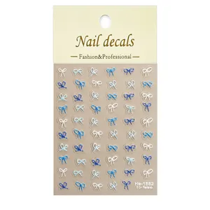 Detailed view of 5D embossed blue and white bow nail art stickers sheet, elegant nail decal close-up.