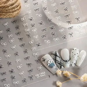 5D embossed nail stickers detail showing cute black and white bows and polka dots design.