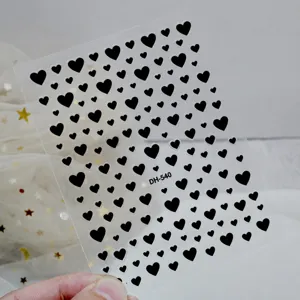 Detail view of 3D black heart nail art stickers with self-adhesive backing design.