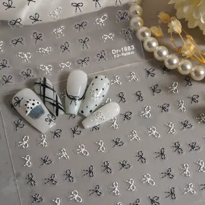 5D gepraegte Nagelsticker mit niedlichen schwarz-weissen Schleifen und Punktedesign.