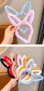 Close-up details of soft plush bunny ear headband in multiple colors, cozy hair accessory.