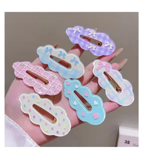Closeup of Korean cute cloud hair clips featuring sweet plaid, bows, and heart patterns.