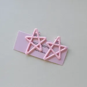 Pink candy color star hair clips detail shot, sweet duckbill clips for girls fringe styling.