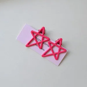 Detail shot of pink hollow star hair clips on display card, cute daily accessory for sweet style.