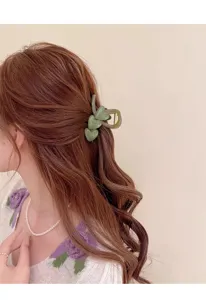 Green heart hair claw clip detail shot, showing the translucent jelly texture and elegant design.