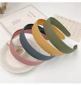 Detailed shot of trendy wide frosted hair hoops in multiple colors, elegant everyday hair accessory.