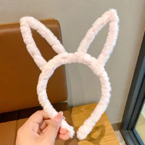 Cute plush bunny ear headband for girls, soft fuzzy winter hair hoop, sweet pink design.