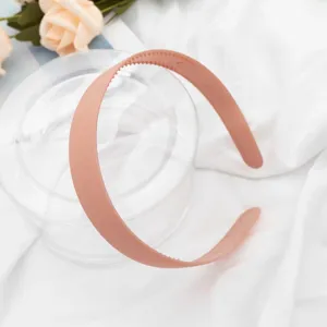 Detailed view of a minimalist matte wide headband in nude pink, perfect for daily fashion.