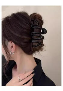 Minimalist black wave hair claw clip for women, stylish geometric shark clip for updos.