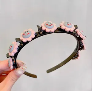 Close-up detail of a cute black hair hoop with pink flower smiley clips for daily styling use.