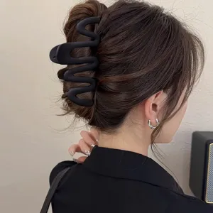 Matte black wavy hair claw clip for women, stylish geometric hair catcher for daily styling.