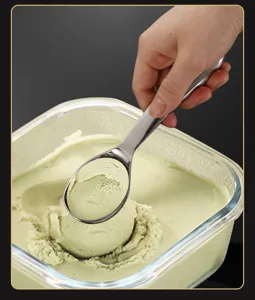 Close-up of stainless steel ice cream scoop in action, scooping smooth dessert effortlessly.