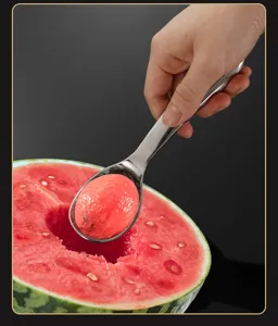 Stainless steel watermelon baller detail close-up showing easy fruit scooping action in kitchen.