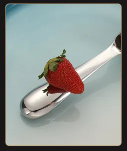 Stainless steel ice cream spoon handle detail, polished metal finish close up view.
