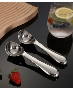 Detail shot of stainless steel ice cream spoon, polished finish with smooth ergonomic handle.