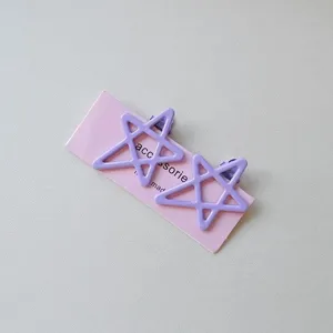 Detail view of cute candy color star hair clips with duckbill design for sweet girl styling.
